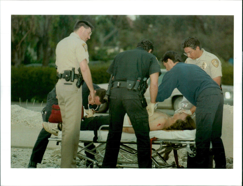 Paramedicts attend to a man who stole an m-60 tank. - Vintage Photograph