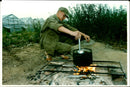 A soldier take a break from the harvest. - Vintage Photograph