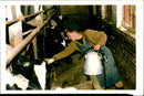Russian Soldier master a new skill milking. - Vintage Photograph