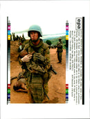 An Un soldier carries a hutu child. - Vintage Photograph