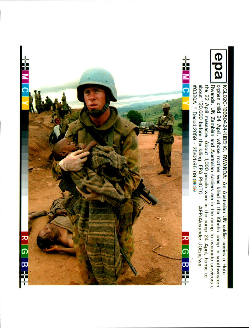 An Un soldier carries a hutu child. - Vintage Photograph