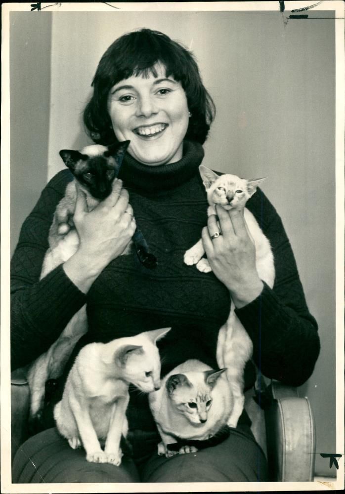 A rare type of siamese in the arms of Annette Stenner. - Vintage Photograph