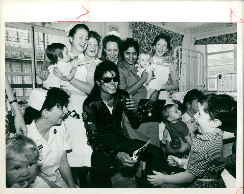 Michael Jackson with young patients and nurses. - Vintage Photograph