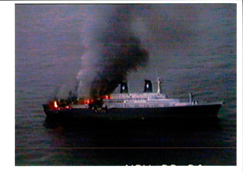 Fires continue to burn inside the Italian Ship Achille Lauro. - Vintage Photograph