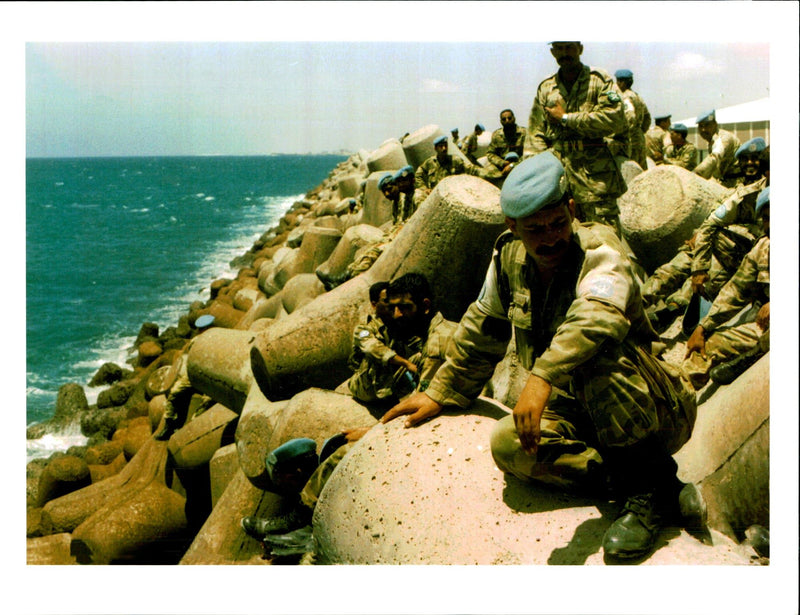 A pakistani soldier takes in a cooling breeze. - Vintage Photograph