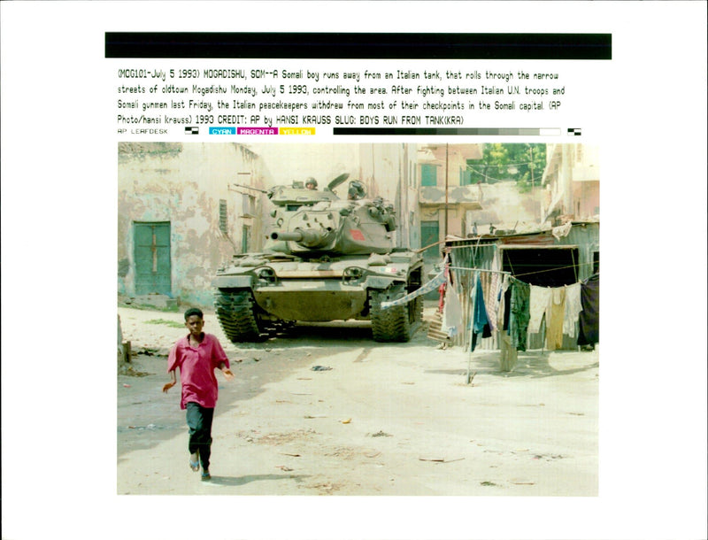 A somali boy runs away from an italian tank. - Vintage Photograph