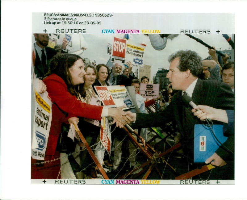 British politician William Waldegrave (R) shakes hands with an animal rights activist - Vintage Photograph