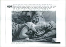 U.S. 5th Army MASH Unit nurse Amy Stuart sleeps with lady a teddy bear between. - Vintage Photograph