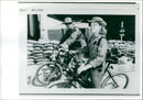 Two soldiers biking on the street. - Vintage Photograph