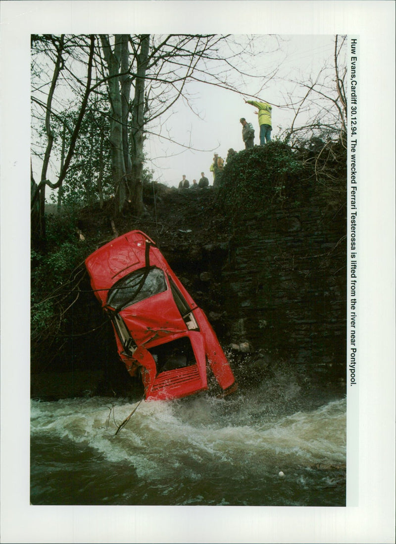 The wrecked Ferrari Testerossa is lifted from the river. - Vintage Photograph