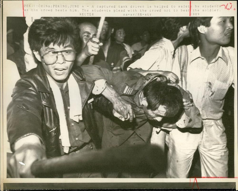 A Captured tank driver is beaten. - Vintage Photograph