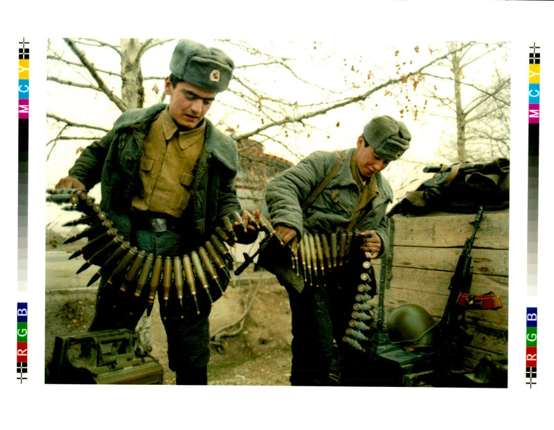 Two soldiers of the Tajik Government Army prepare to load weapon. - Vintage Photograph