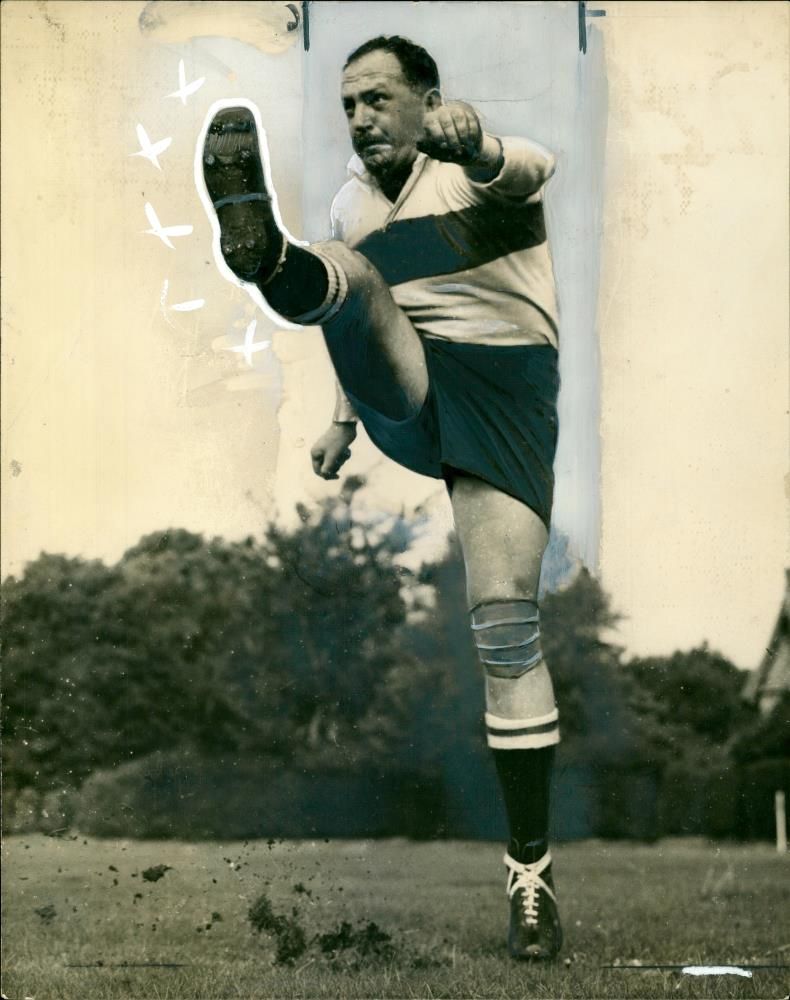 A. Ockey Geffin top kicker shoots up as he is pictured. - Vintage Photograph