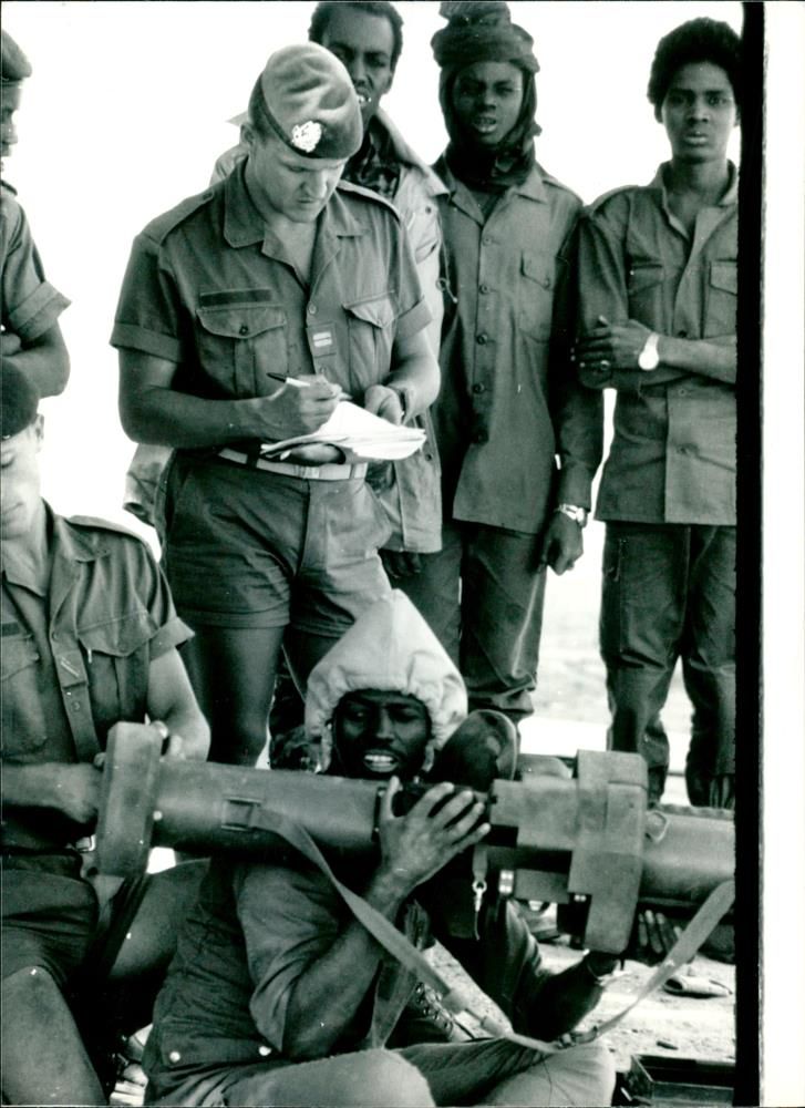 French officer instructs a young Chadian soldier. - Vintage Photograph