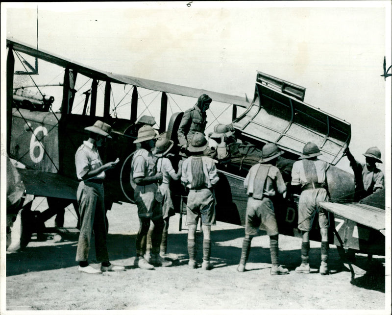 A british soldier being put aboard an aircraft in  somaliland. - Vintage Photograph