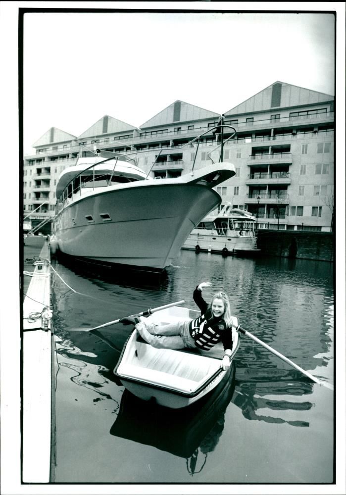 A photograph of a young girl at the boat smiling. - Vintage Photograph