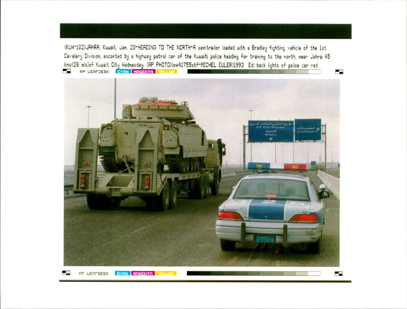 Bradley fighting vehicle of the 1st Cavalery Division, escorted by a highway patrol car of the Kuwait police. - Vintage Photograph