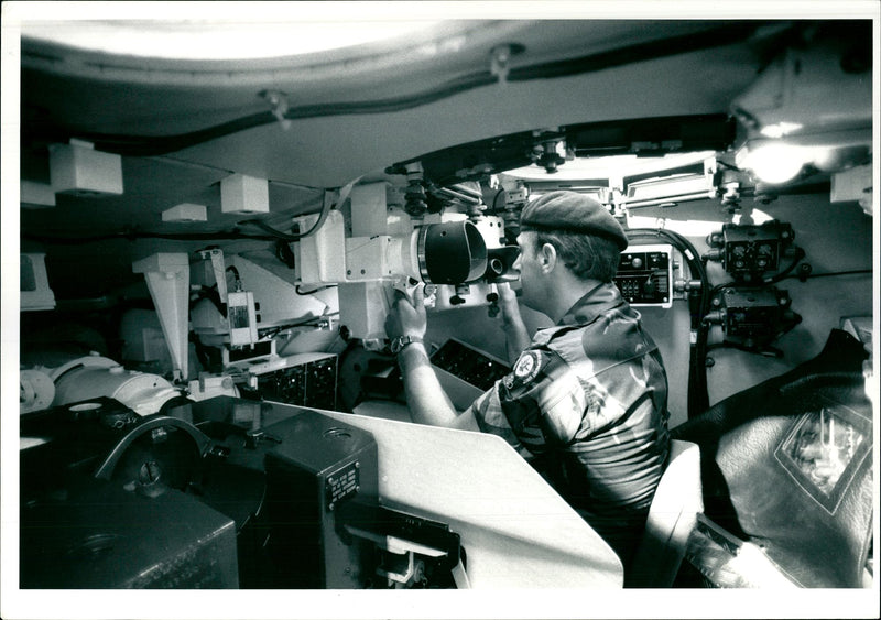 A British army officer inspecting inside equipment of 'Challenger 1' tank - Vintage Photograph