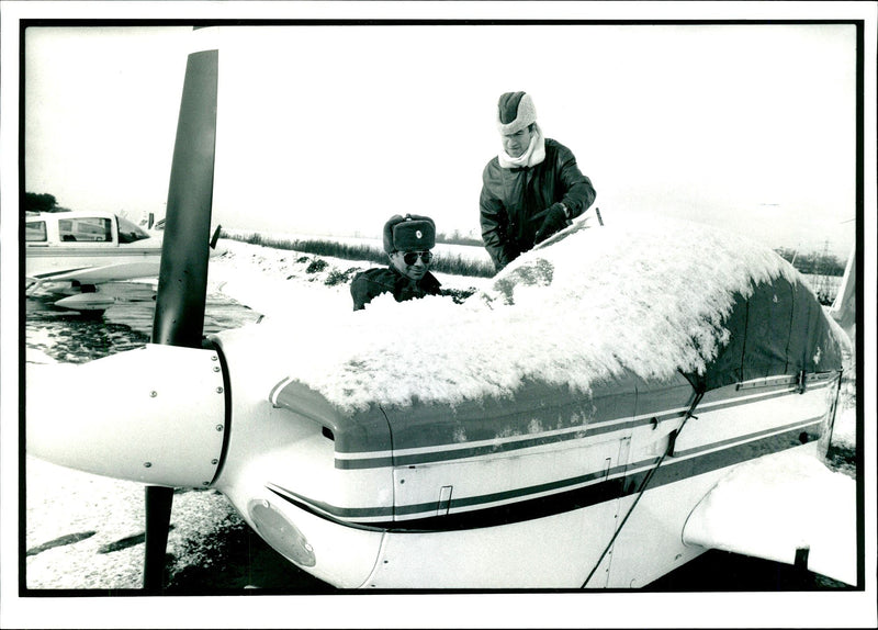 Pilots clearing snow from the planes at Elstree Aerodrome - Vintage Photograph