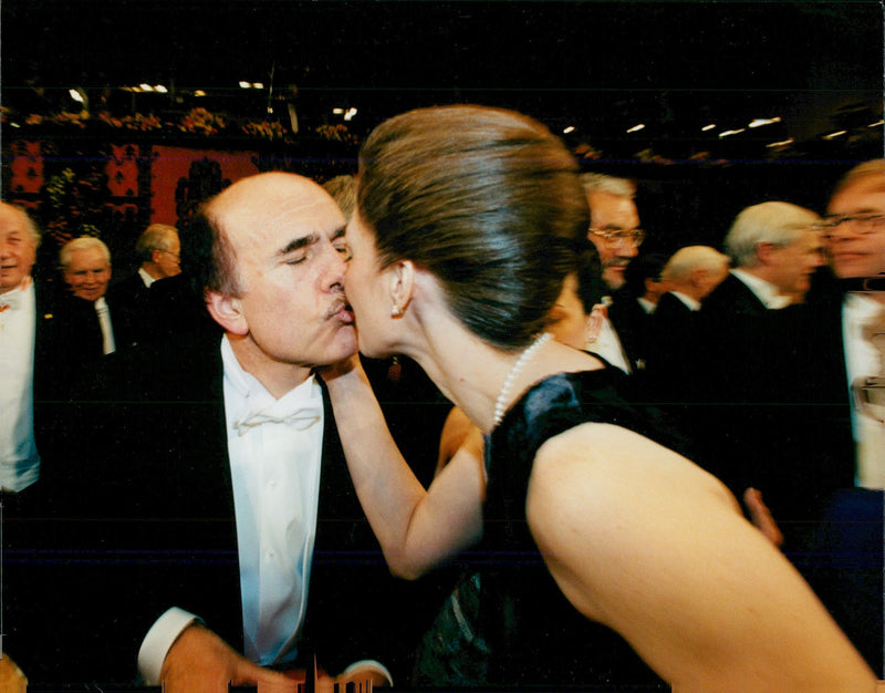 Nobel Laureate Louis J. Ignarro kisses his wife at the 1998 Nobel Prize in the Concert Hall. - Vintage Photograph