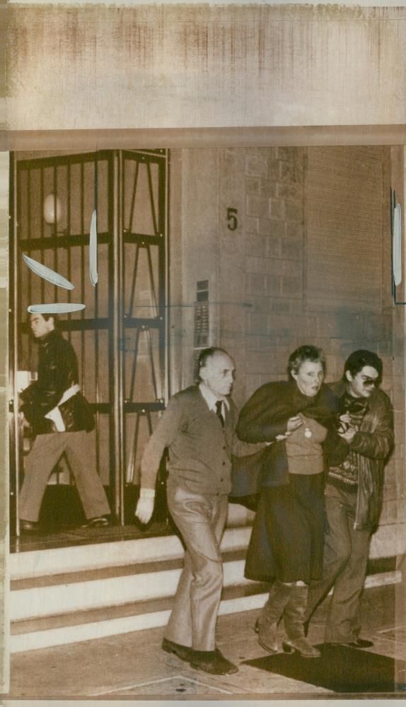 Mrs Judith Dozier being helped as she left her home in Verona after the kidnapping of her husband - Vintage Photograph