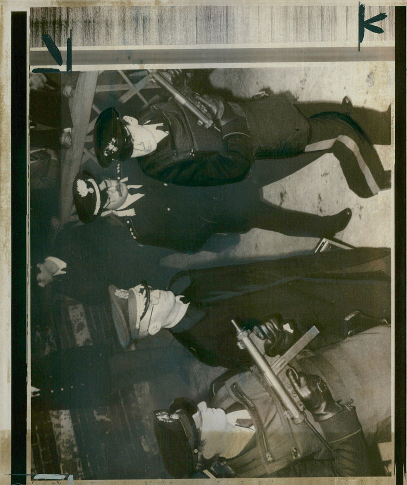 A paramilitary policeman armed with a machine gun guard Gen. Dozier as he arrived at the court - Vintage Photograph