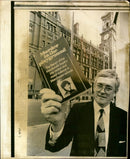 Ian Macdonald holding the book '' Murder in the playground - Vintage Photograph