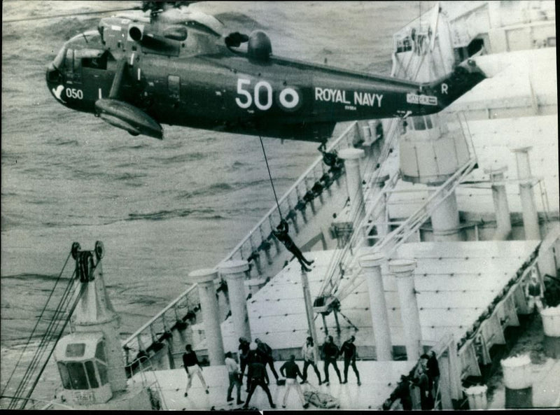 A helicopter from the Royal Naval air station rescuing members of the crew of the fire-ravaged Anatina - Vintage Photograph