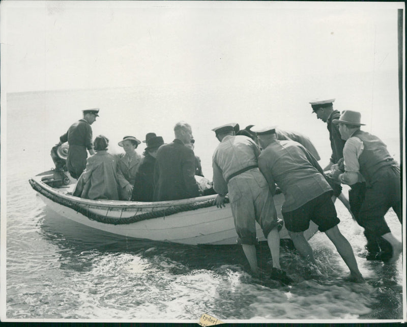 Men help bring out a boat - Vintage Photograph