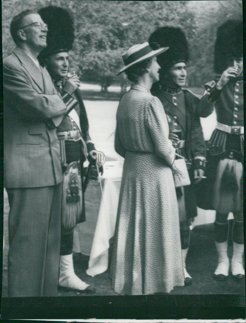 The Crown Prince couple acquainted themselves with a couple of the Scottish regiment's musicians. - Vintage Photograph