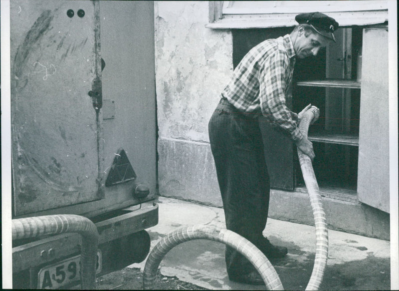 The Milk Central (Mjölkcentralen). Driver Oskar Andersson takes tubes from the tank to the milk tank - Vintage Photograph