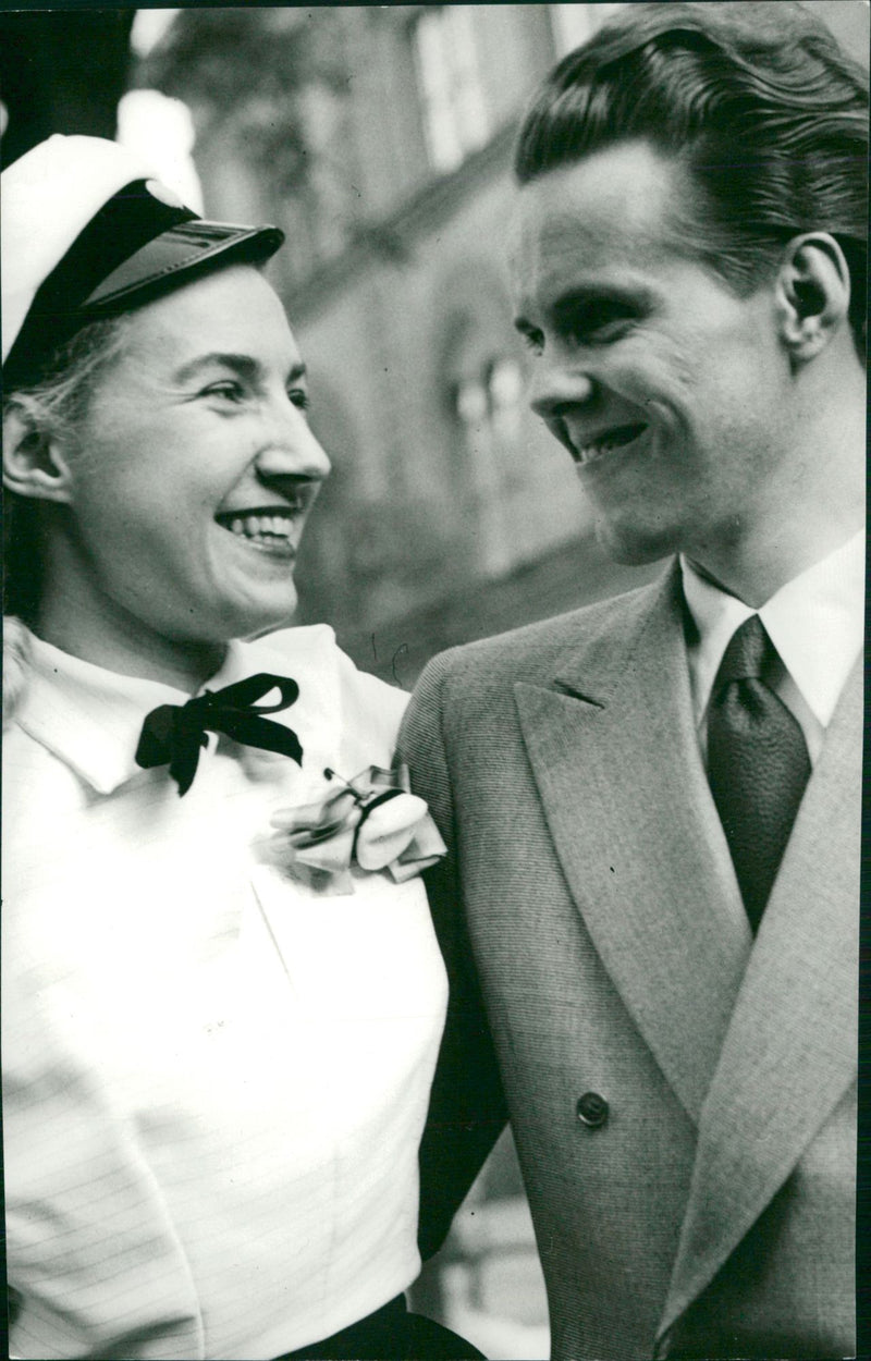 Housewife, postal clerk and student- Maj-Britt Rudewald gets a hug from her husband Sven. - Vintage Photograph