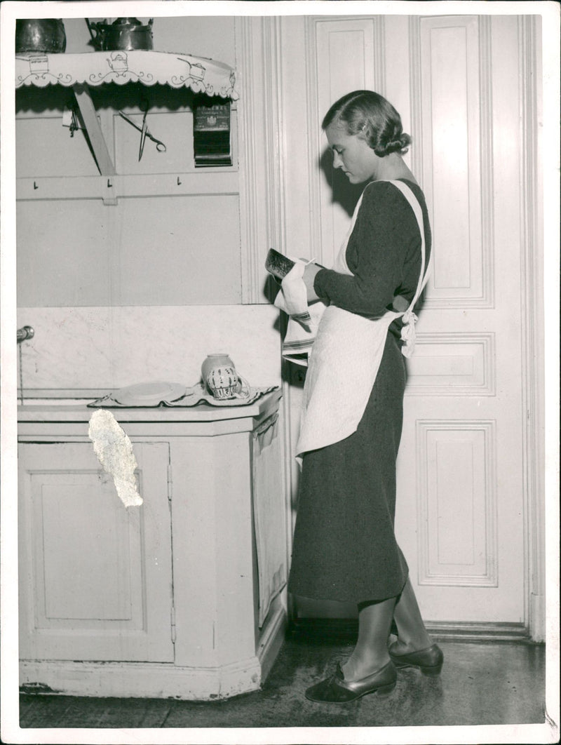 Maid doing household chores. - Vintage Photograph