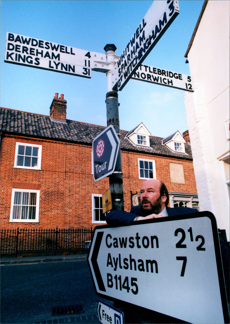 British writer Keith Skipper poses with street signs - Vintage Photograph