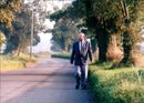 British writer Keith Skipper walks on the road - Vintage Photograph