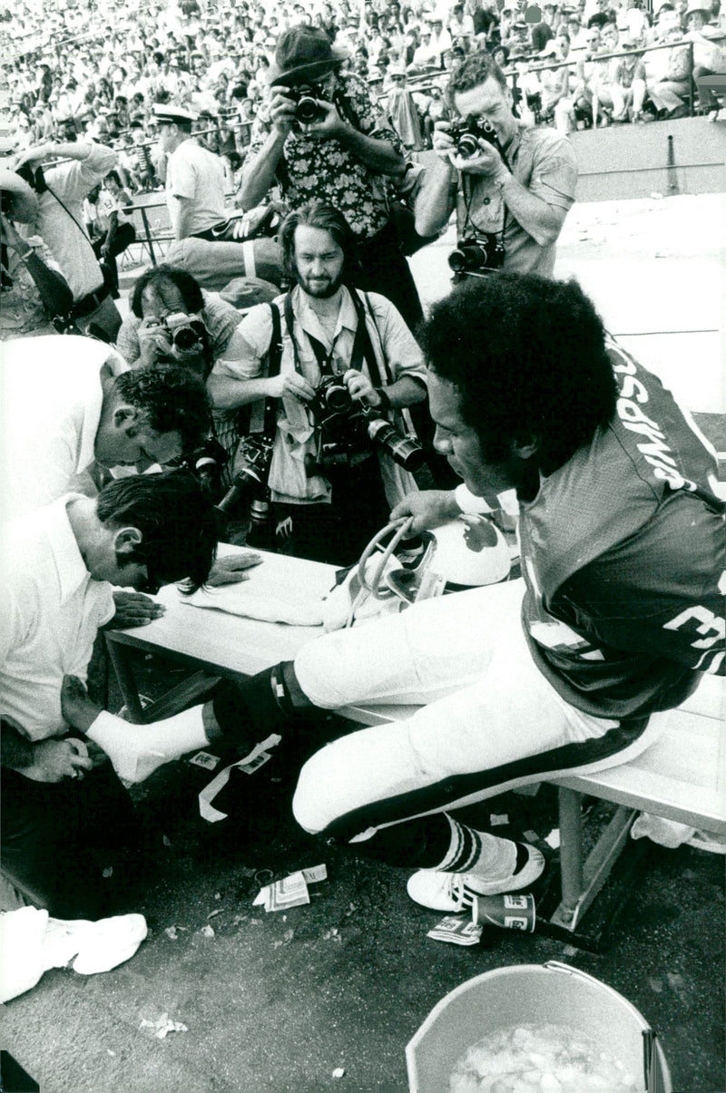 O. J. Simpson on the bench for special tape job - Vintage Photograph