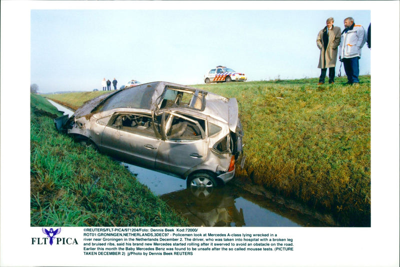 Mercedes A-class lying wrecked in a river - Vintage Photograph