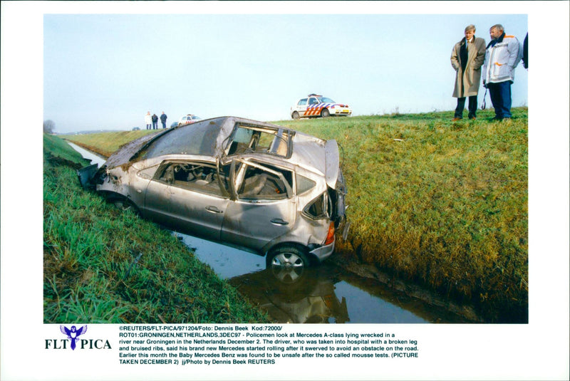 Mercedes A-class lying wrecked in a river - Vintage Photograph