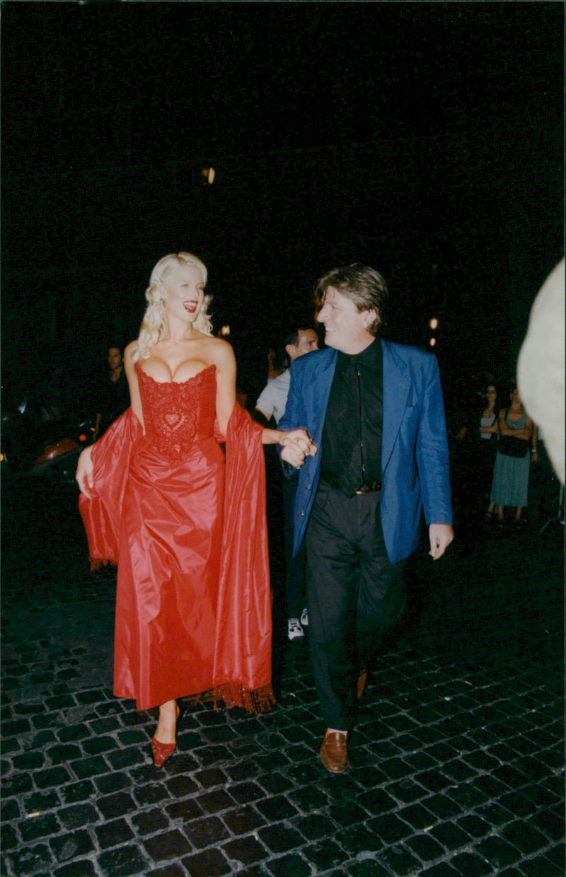 Swedish photo model Victoria Silvstedt in a red dress with Bruno Bevilacqua - Vintage Photograph