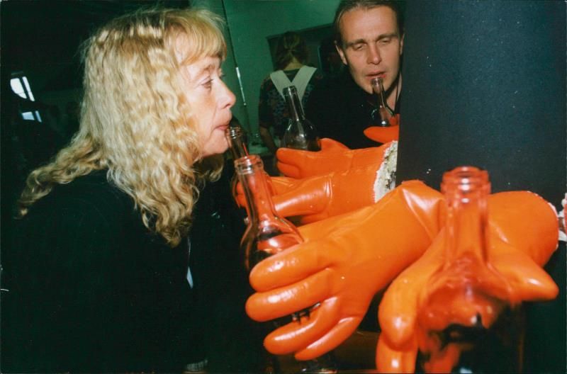 Marie Selander tries the tone of a prepared empty bottle in Tuomo Haapala's engineered musical instrument - Vintage Photograph