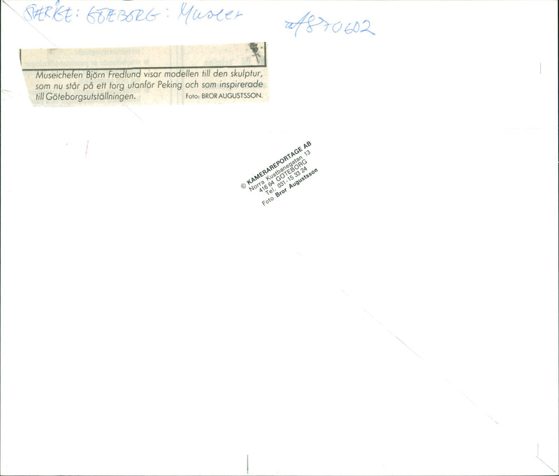 Museum manager BjÃ¶rn Fredlund shows the model of a sculpture standing on a square outside Beijing, which inspired the Gothenburg exhibition. - Vintage Photograph