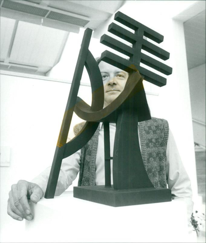 Museum manager BjÃ¶rn Fredlund shows the model of a sculpture standing on a square outside Beijing, which inspired the Gothenburg exhibition. - Vintage Photograph