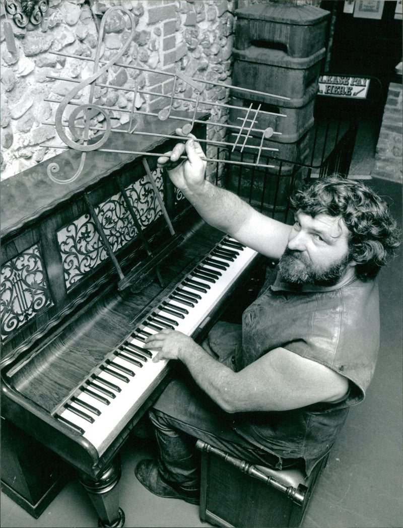 Roy Masters making music in iron bars and on an electronic piano - Vintage Photograph