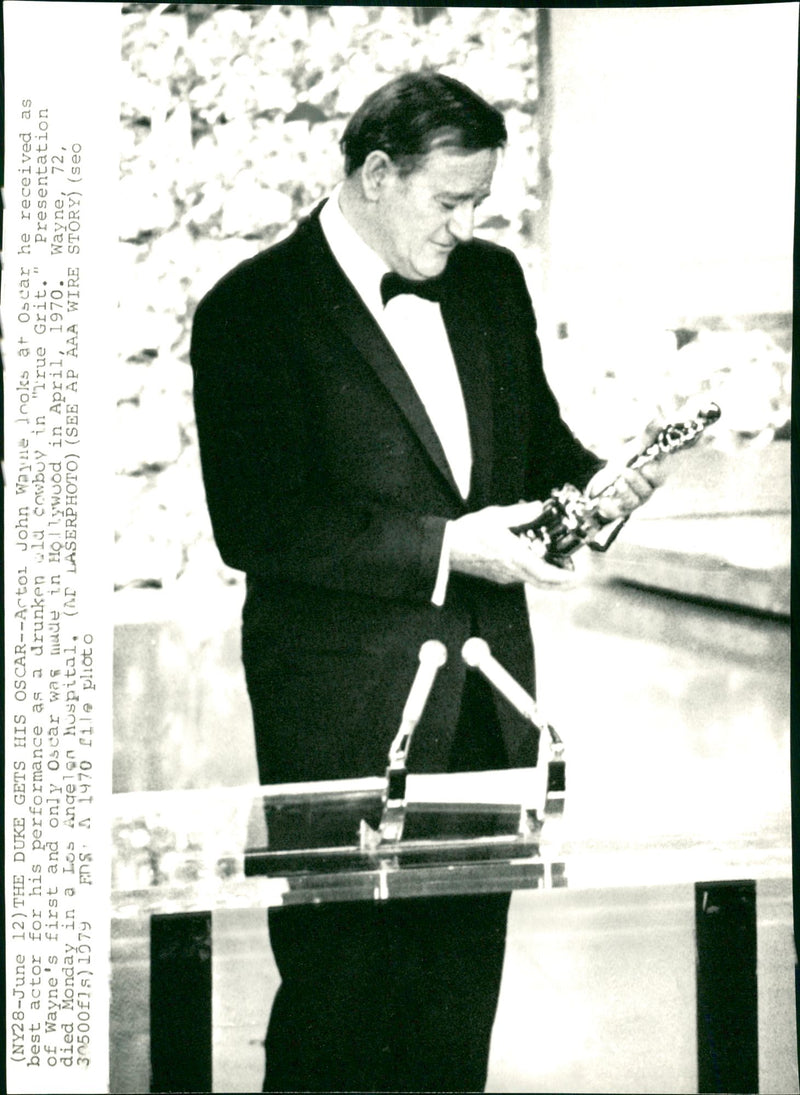 Actor John Wayne looks at Oscar - Vintage Photograph