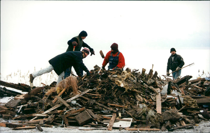People clean up bread in house ruin after fire in Vaxholm - Vintage Photograph