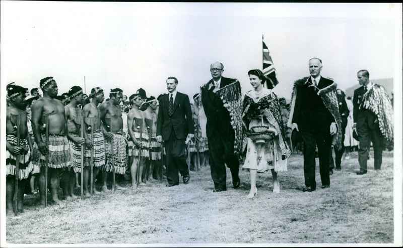 Queen Elizabeth II tour New Zealand. Maori warriors standing in line to see the the Queen and the Duke of Edinburgh efter the Maori reception held in Arawa Park, Rotorua - Vintage Photograph
