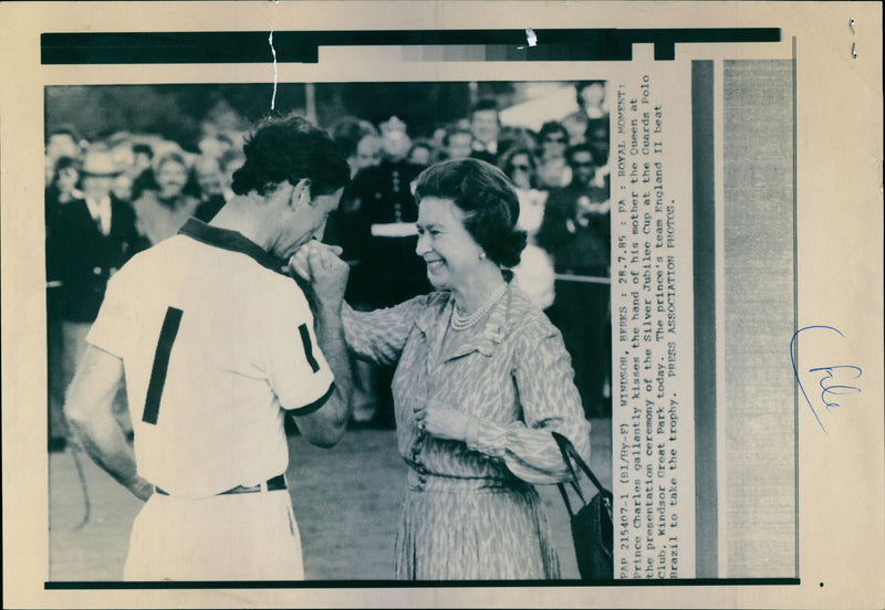Prince Charles kisses the hand of his mother Queen Elizabeth at the presentation ceremony of the Silver Jubilee Cup at the Guards Polo Club in Windsor Great Park - Vintage Photograph