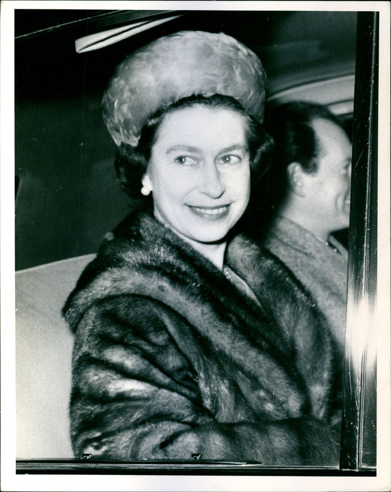 A smile from Queen Elizabeth II as she is driven away from Liverpool Street Station in London - Vintage Photograph