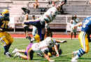 SM final in American football at Stockholm Stadium. 22-year-old running back Fredrik Nanhed  on his knees closest to the camera. - Vintage Photograph
