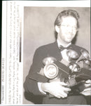 Eric Clapton is loaded with the six Grammys he was awarded at annual Grammy Awards in Los Angeles. - Vintage Photograph